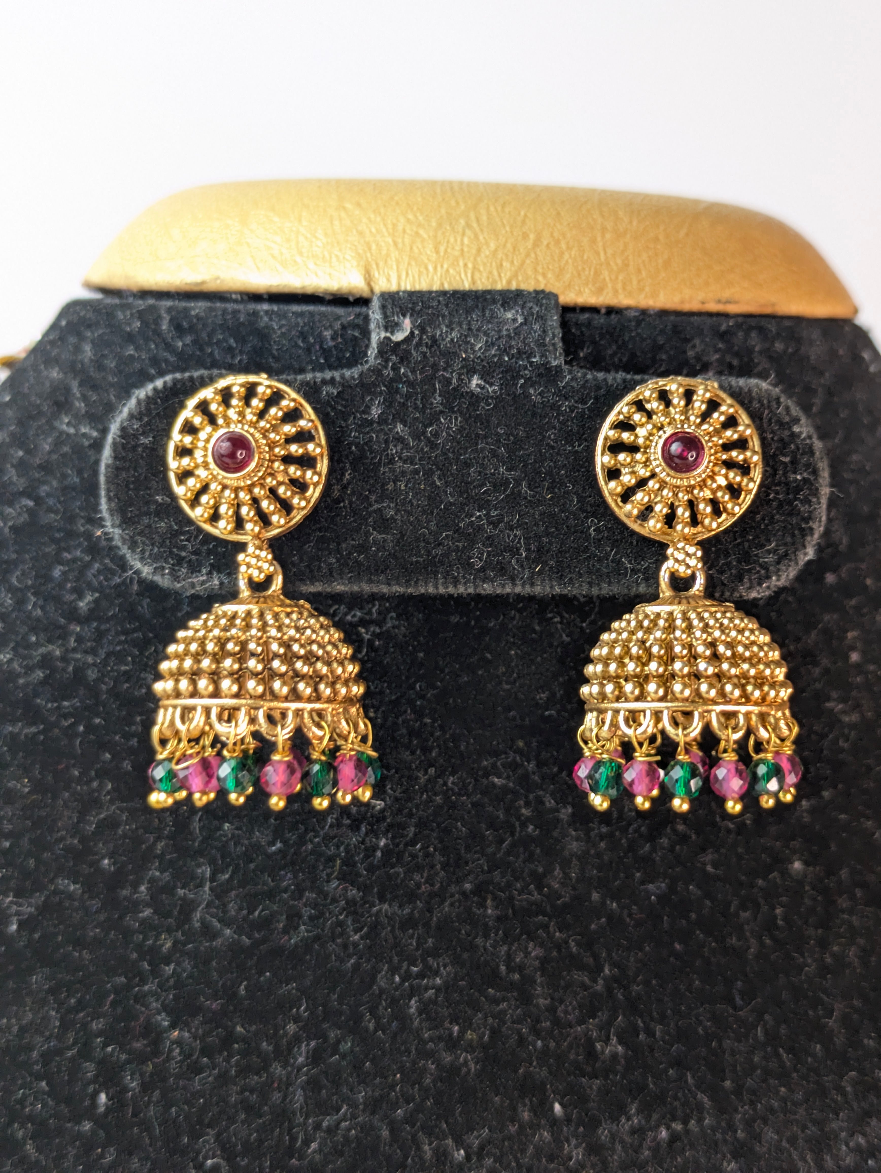Temple jewelry design with an antique gold-plated finish.